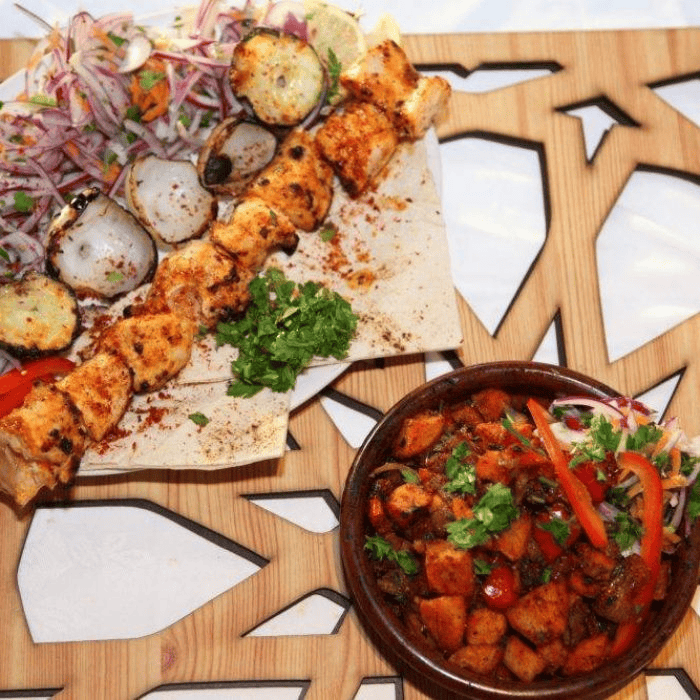 Authentic Lebanese chicken Shish Taouk skewers served with Batata Harra and fresh salad at Lebanese Village.