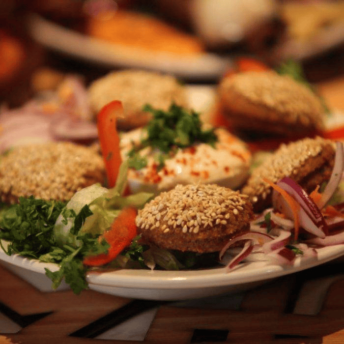 Authentic Lebanese sesame falafel starter platter served with tahini and fresh salad at Lebanese Village.