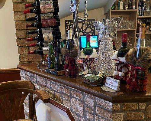 Lebanese Village restaurant bar area decorated with wine bottles and festive holiday ornaments